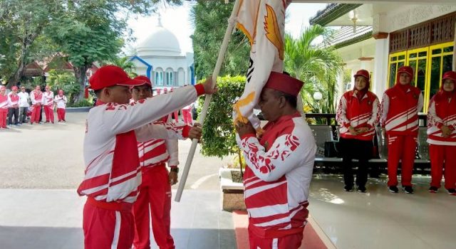 WhatsApp Image 2018-11-16 at 17.41.48 Bupati Pidie, Roni Ahmad alias Abusyik, mencium bendera Koni yang diserahkan Ketua Koni, Samsul Bahri, pada acara pelepasan kontingen Pora Pidie di Pendopo Bupati Pidie, Jumat (16/11/2018). (Foto/Muhammad Riza)