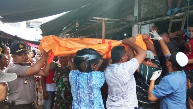 WhatsApp Image 2018-11-17 at 15.36.38 Kapolsek Langsa Kota, AKP Salmidin dibantu warga saat mengevakuasi jenazah Muslim yang ditemukan tewas di kios kayu Pajak Pisang berlantai dua Jalan Parik Es Kota Langsa, Sabtu (17/11/2018). (Foto/dede)