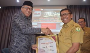 Kepala Dinas Sosial Aceh menerima pengharhgaan dari GeRAK yang diserahkan oleh Plt Gubernur Aceh. (Foto/Ist)
